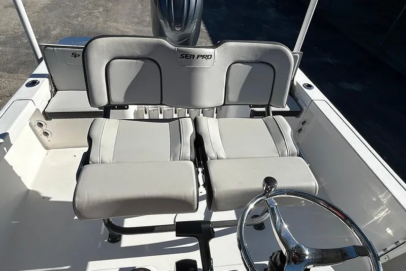 Slide: The Image of 2026 Sea Pro 210 Bay boat interior with dual seats and steering wheel. - 36