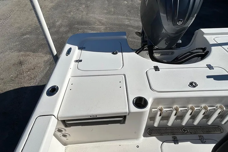 Slide: The Image of 2026 Sea Pro 210 Bay boat deck with motor and storage compartments. - 38