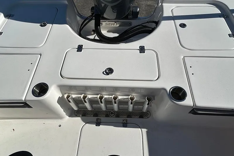 Slide: The Image of 2026 Sea Pro 210 Bay boat deck with storage compartments and rod holders. - 42
