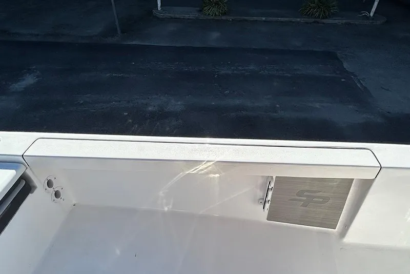 Slide: The Image of 2026 Sea Pro 210 Bay boat interior with storage compartment and sleek design. - 44