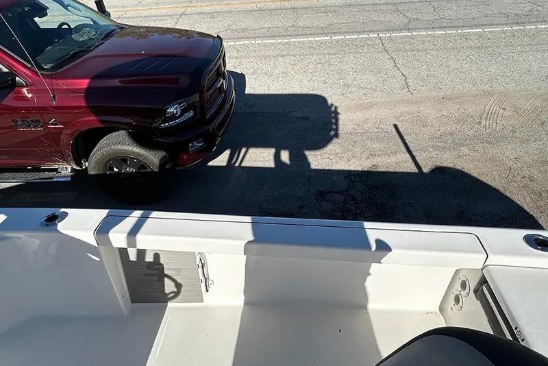 Slide: The Image of 2026 Sea Pro 210 Bay boat interior with red truck in background. - 45