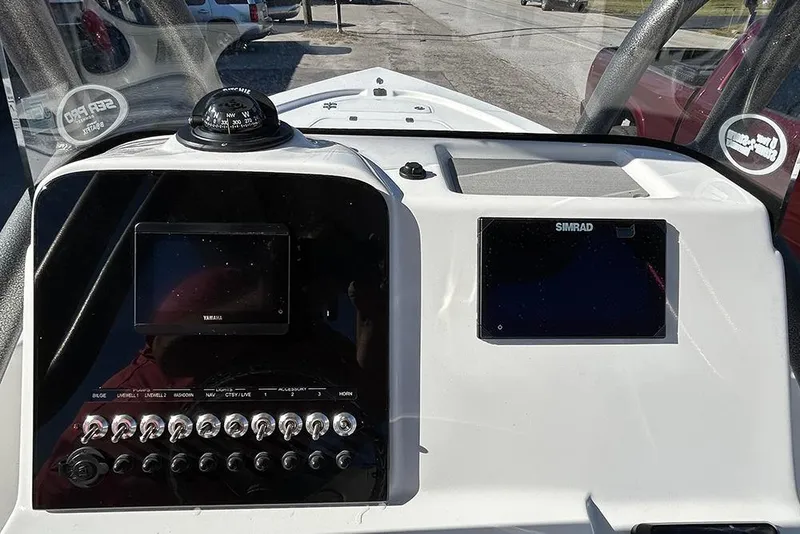 Slide: The Image of 2026 Sea Pro 210 Bay boat dashboard with navigation screens and controls. - 46