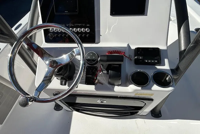 Slide: The Image of Steering console of 2026 Sea Pro 210 Bay boat with controls and cup holders. - 47