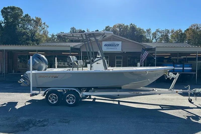 Slide: The Image of 2026 Sea Pro 210 Bay boat on trailer outside dealership, sunny day. - 6