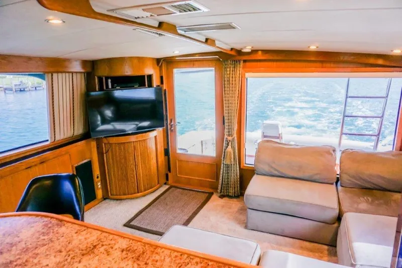 Slide: The Image of Interior of a 1987 Bertram 54 Convertible yacht with cozy seating and ocean view. - 10