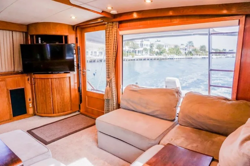 Slide: The Image of Luxurious interior of 1987 Bertram 54 Convertible yacht with waterfront view. - 11