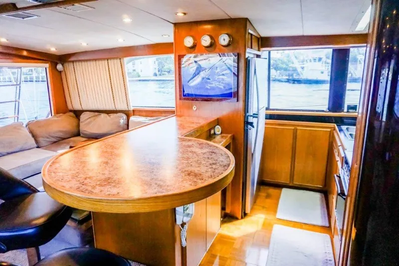 Slide: The Image of Interior of 1987 Bertram 54 Convertible yacht with modern kitchen and cozy seating area. - 14