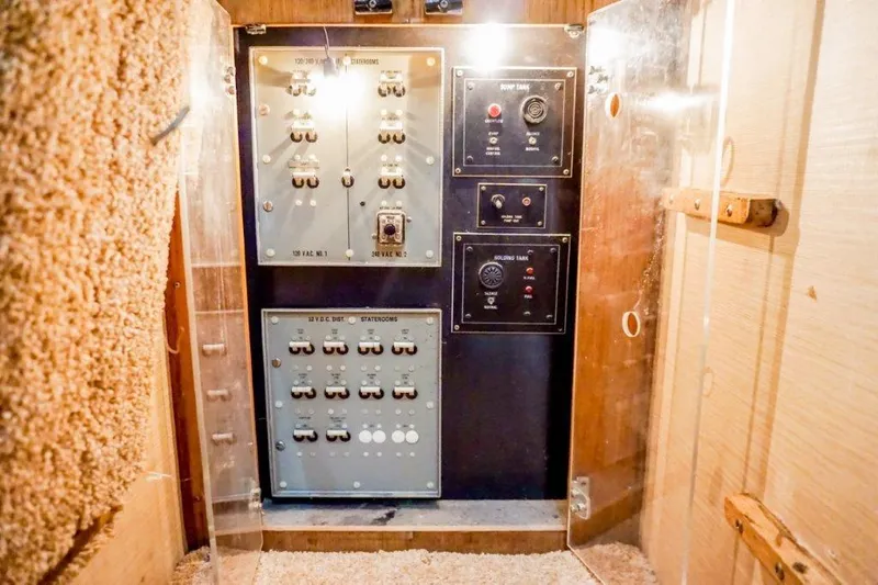 Slide: The Image of Electrical panel inside a 1987 Bertram 54 Convertible yacht, showcasing switches and controls. - 17
