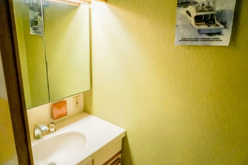 Slide: The Image of 1987 Bertram 54 Convertible bathroom with mirror, sink, and wall art. - 23