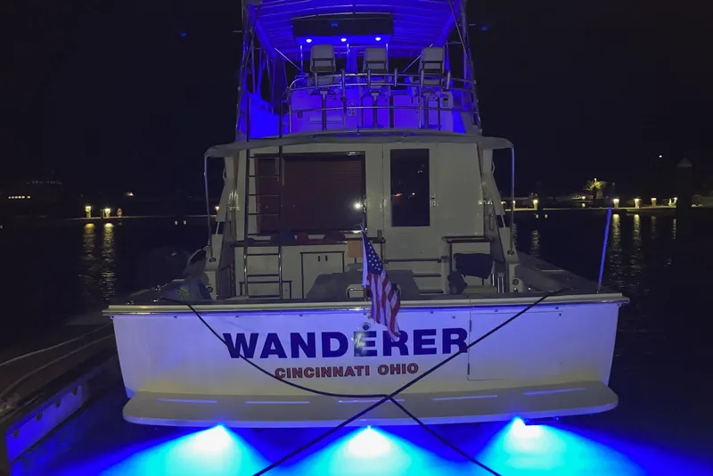 Slide: The Image of 1987 Bertram 54 Convertible yacht "Wanderer" with blue lights at night, Cincinnati, Ohio. - 24