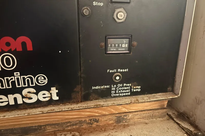 Slide: The Image of Control panel of a 1987 Bertram 54 Convertible marine generator with hour meter and fault indicators. - 30