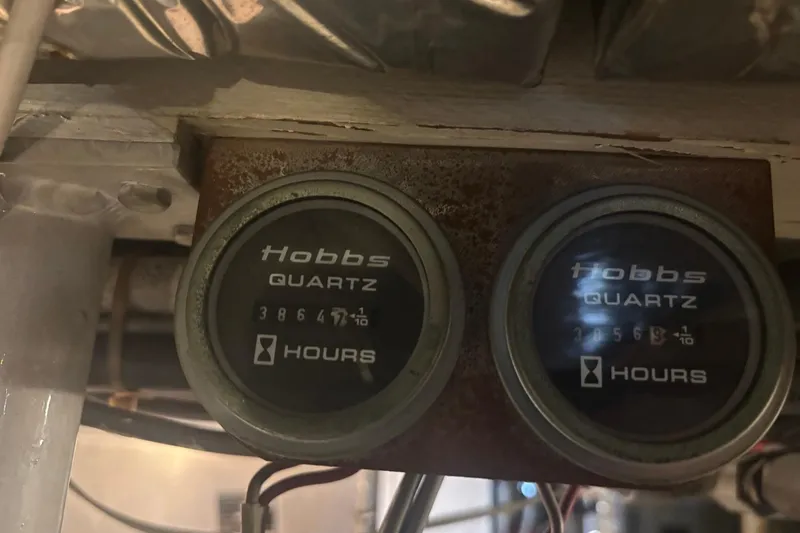 Slide: The Image of Hobbs hour meters on a 1987 Bertram 54 Convertible boat, displaying engine hours. - 31