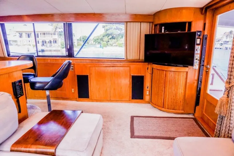 Slide: The Image of Interior of 1987 Bertram 54 Convertible yacht with wood paneling and modern amenities. - 6