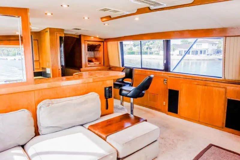 Slide: The Image of Luxurious interior of 1987 Bertram 54 Convertible yacht with plush seating and wooden accents. - 7
