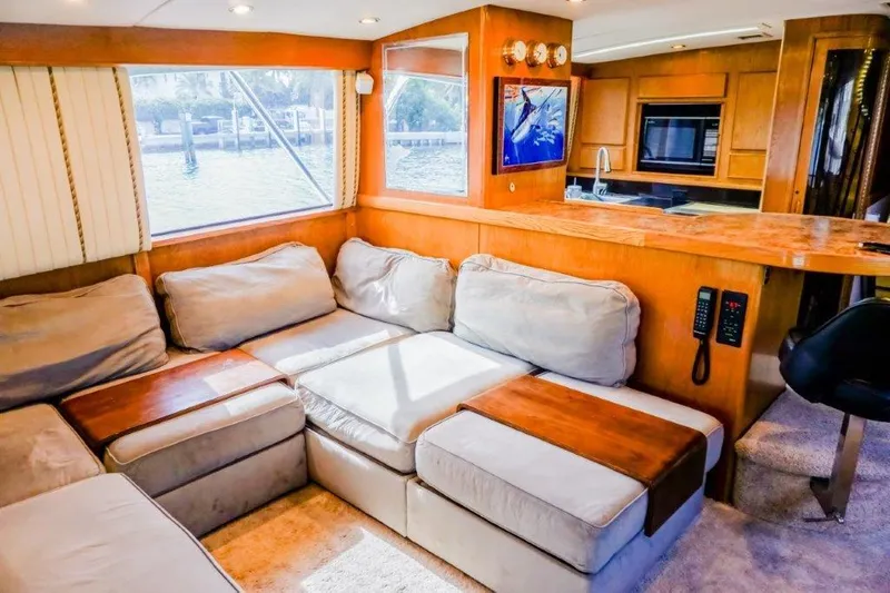 Slide: The Image of Luxurious interior of a 1987 Bertram 54 Convertible yacht with plush seating and modern kitchen. - 8