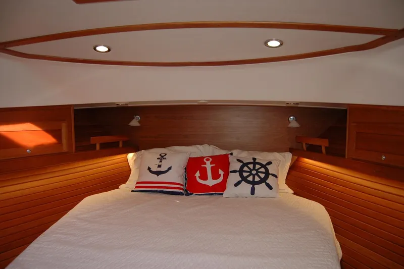 Slide: The Image of Cozy cabin bedroom in 2019 Sabre 38 Salon Express with nautical-themed pillows. - 103