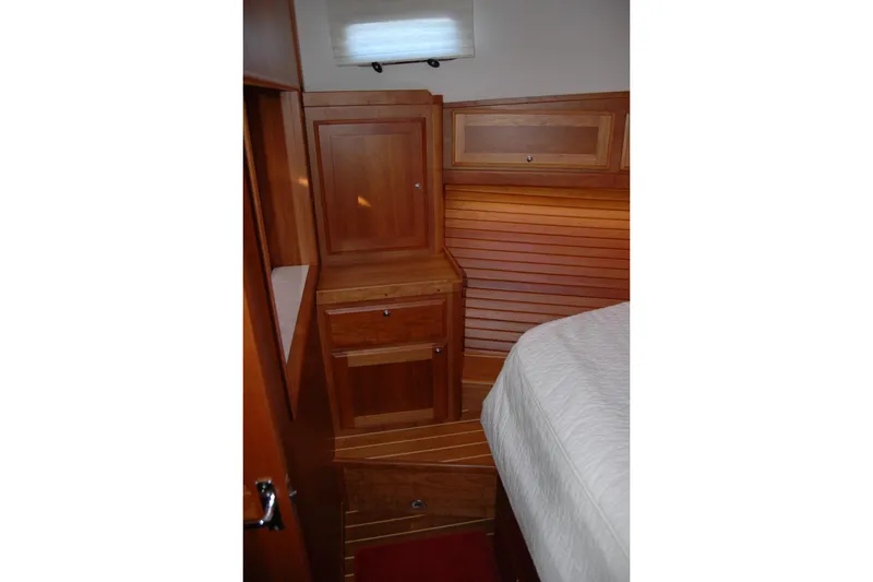 Slide: The Image of 2019 Sabre 38 Salon Express cabin interior with wooden cabinetry and bed. - 105