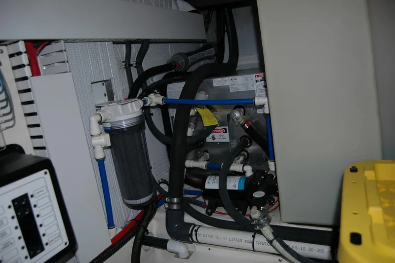 Slide: The Image of Engine room of 2019 Sabre 38 Salon Express with complex piping and filtration system. - 121