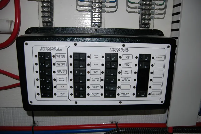 Slide: The Image of Electrical panel on a 2019 Sabre 38 Salon Express boat, showing circuit switches. - 122