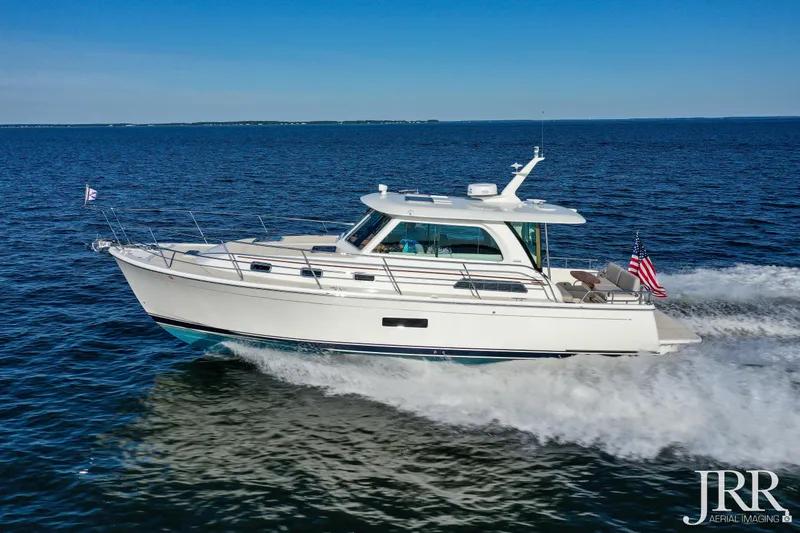Slide: The Image of 2019 Sabre 38 Salon Express cruising on open water under clear blue skies. - 18