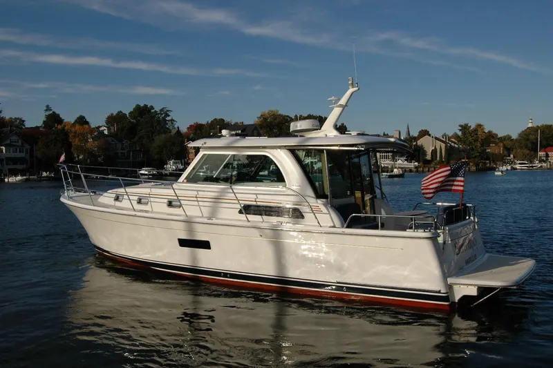 Slide: The Image of 2019 Sabre 38 Salon Express yacht on a serene lake with American flag. - 3