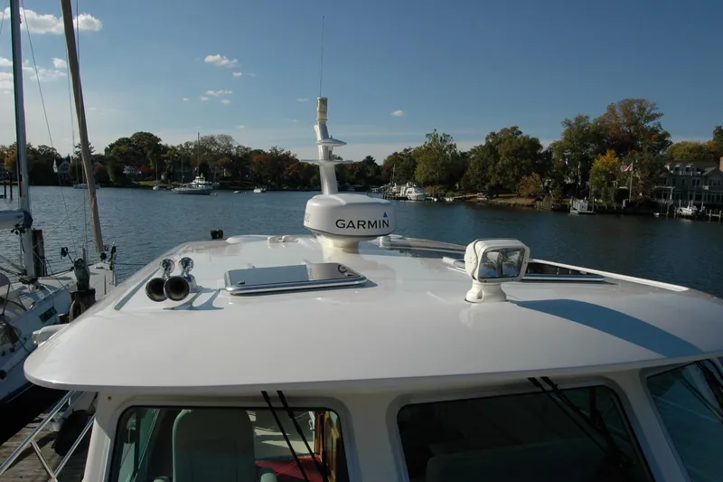 Slide: The Image of 2019 Sabre 38 Salon Express yacht with Garmin equipment, docked by a scenic waterfront. - 30