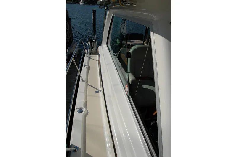 Slide: The Image of 2019 Sabre 38 Salon Express yacht side deck with railing and window view. - 33