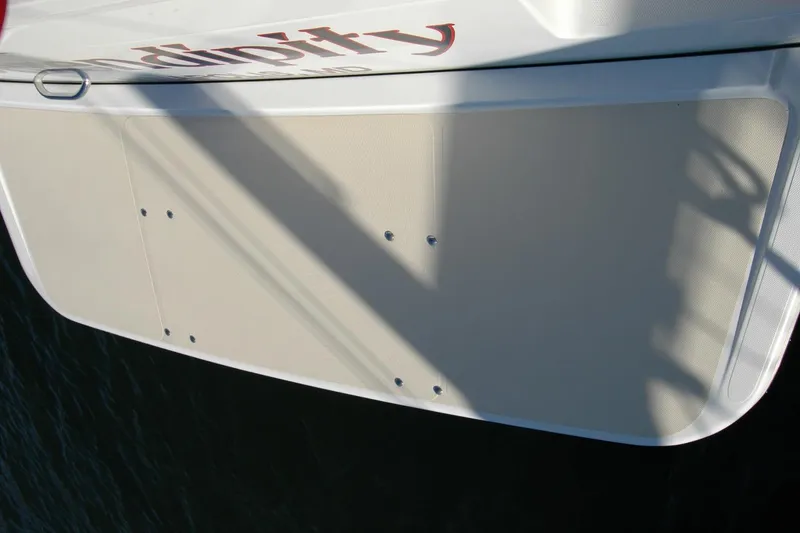 Slide: The Image of 2019 Sabre 38 Salon Express boat stern platform with shadow and partial name visible. - 42