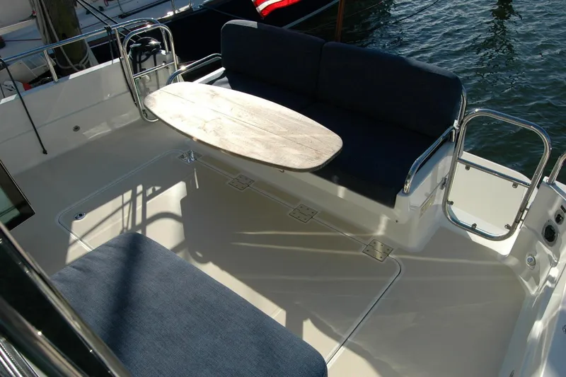 Slide: The Image of 2019 Sabre 38 Salon Express deck with seating and table, docked by water. - 43