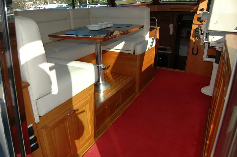 Slide: The Image of Interior of 2019 Sabre 38 Salon Express with red carpet and white seating. - 54