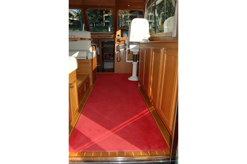 Slide: The Image of Interior of 2019 Sabre 38 Salon Express with red carpet and wooden cabinetry. - 55