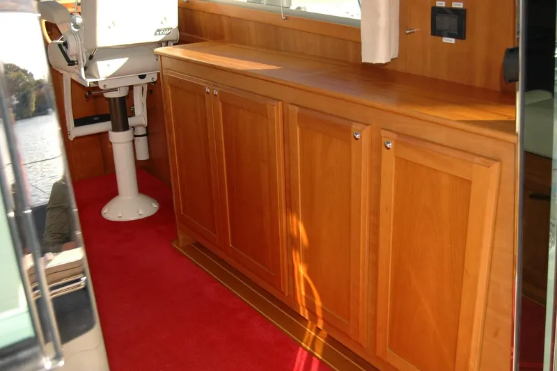 Slide: The Image of Interior of 2019 Sabre 38 Salon Express with wooden cabinetry and red carpet. - 56