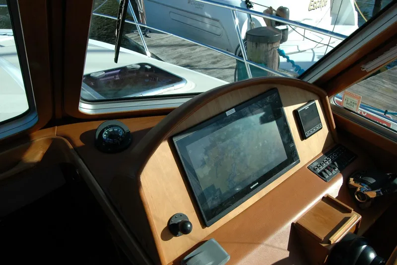 Slide: The Image of 2019 Sabre 38 Salon Express helm with navigation display and controls. - 64