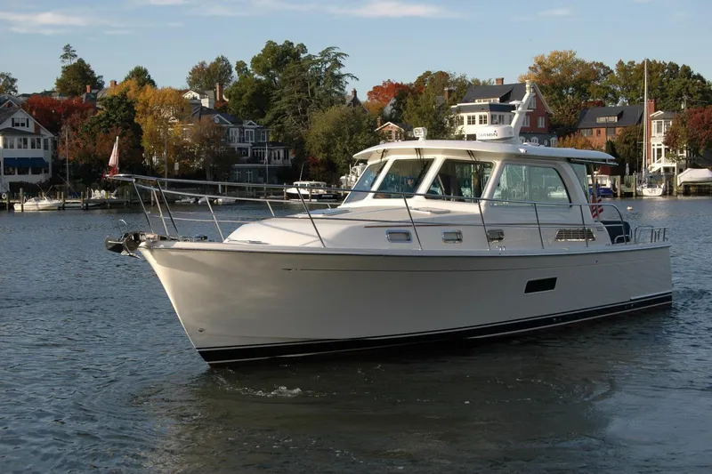 Slide: The Image of 2019 Sabre 38 Salon Express yacht cruising on a scenic waterfront. - 8