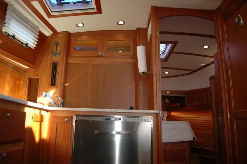 Slide: The Image of 2019 Sabre 38 Salon Express interior with wood cabinetry and stainless steel appliances. - 85