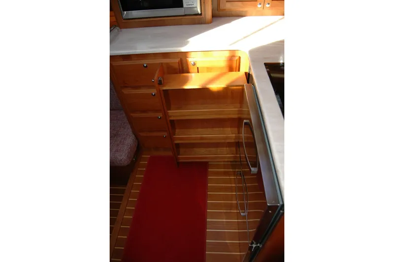 Slide: The Image of 2019 Sabre 38 Salon Express kitchen with wooden cabinetry and pull-out shelves. - 92