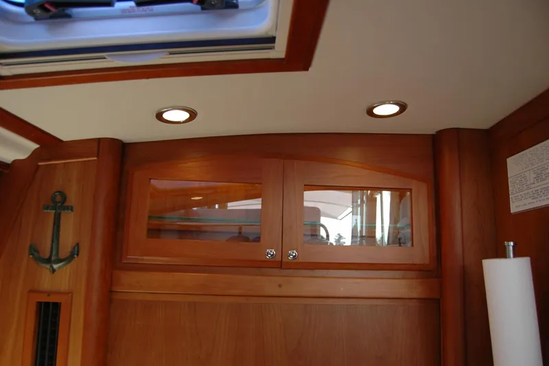 Slide: The Image of Interior of 2019 Sabre 38 Salon Express with wooden cabinets and anchor decor. - 93