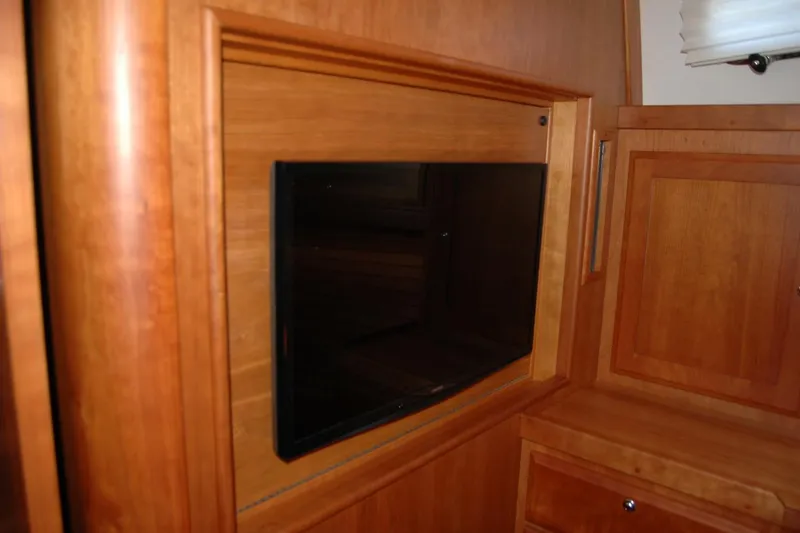 Slide: The Image of Built-in TV in 2019 Sabre 38 Salon Express yacht's wooden interior. - 94