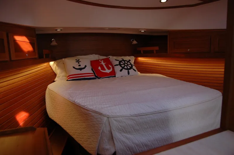 Slide: The Image of Cozy cabin bedroom in 2019 Sabre 38 Salon Express with nautical-themed pillows. - 97