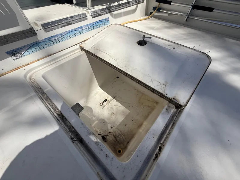 Slide: The Image of Open storage compartment on 2000 Contender 35 Side Console boat deck. - 16