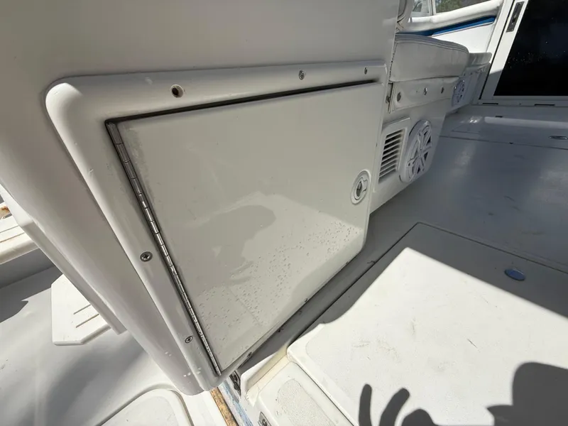 Slide: The Image of 2000 Contender 35 Side Console interior with storage compartment and speaker. - 23