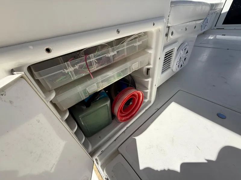 Slide: The Image of Storage compartment on a 2000 Contender 35 Side Console boat with organized gear and supplies. - 24