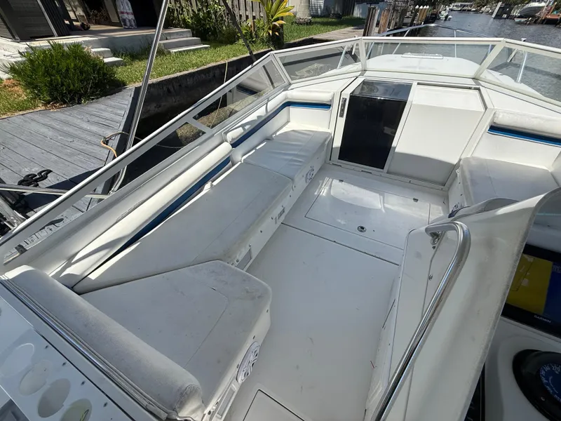 Slide: The Image of 2000 Contender 35 Side Console boat interior with white seating and open deck. - 33