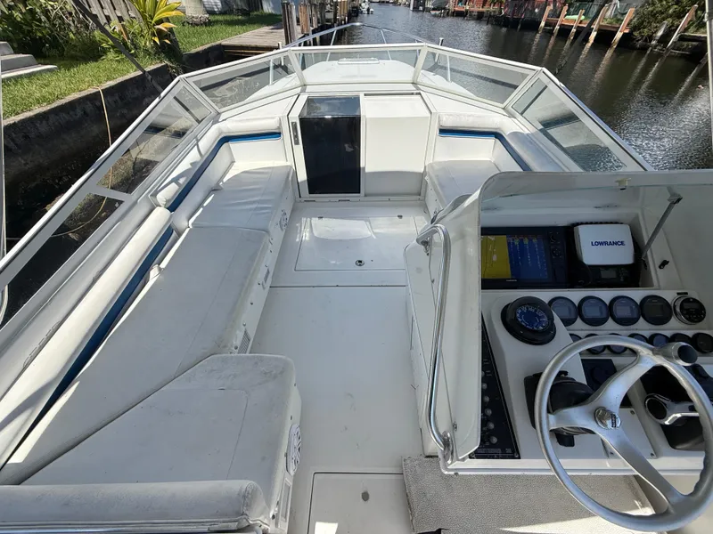 Slide: The Image of 2000 Contender 35 Side Console boat interior with steering wheel and navigation equipment. - 34