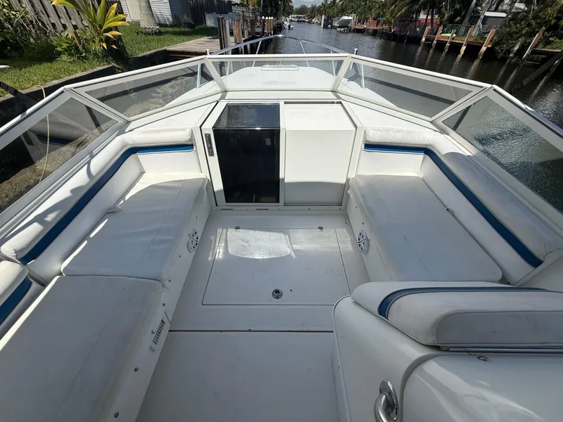 Slide: The Image of 2000 Contender 35 Side Console boat interior with white seating and blue accents. - 35