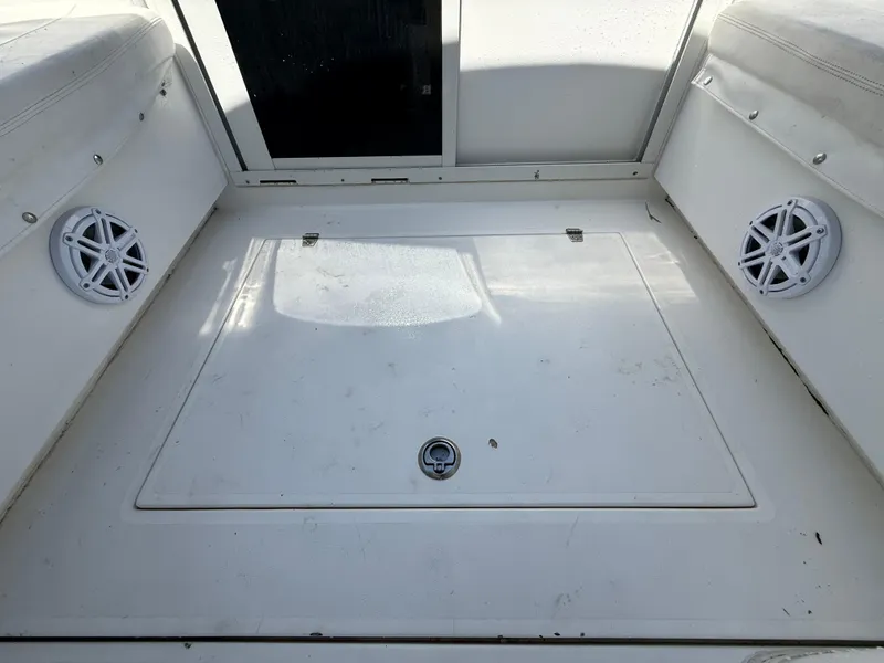 Slide: The Image of Contender 35 Side Console 2000 boat interior with storage hatch and speakers. - 37