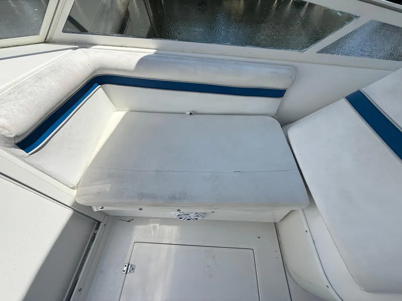 Slide: The Image of Contender 35 Side Console 2000 boat interior with white and blue seating. - 40