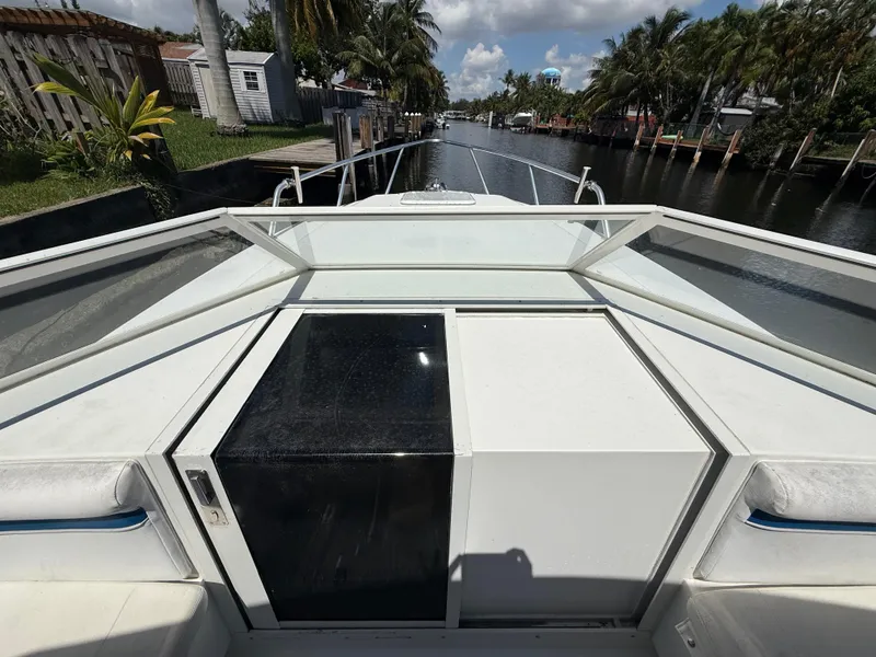 Slide: The Image of Contender 35 Side Console boat, 2000 model, docked in a scenic canal setting. - 43