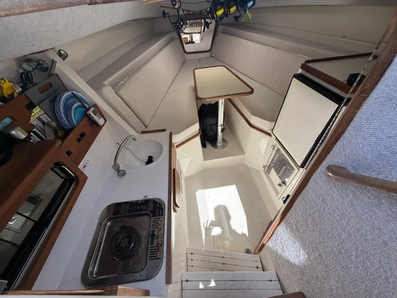 Slide: The Image of Interior of 2000 Contender 35 Side Console boat with kitchenette and seating area. - 44