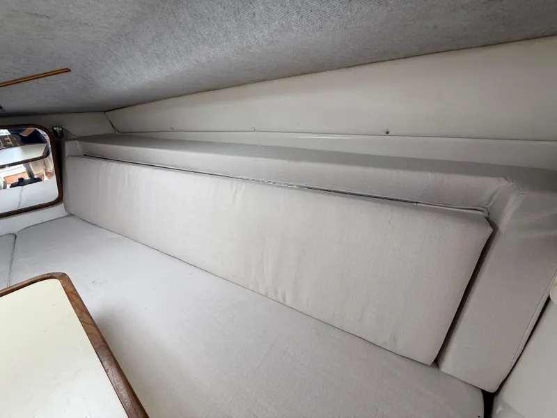 Slide: The Image of Interior cabin of 2000 Contender 35 Side Console with cushioned seating and table. - 48